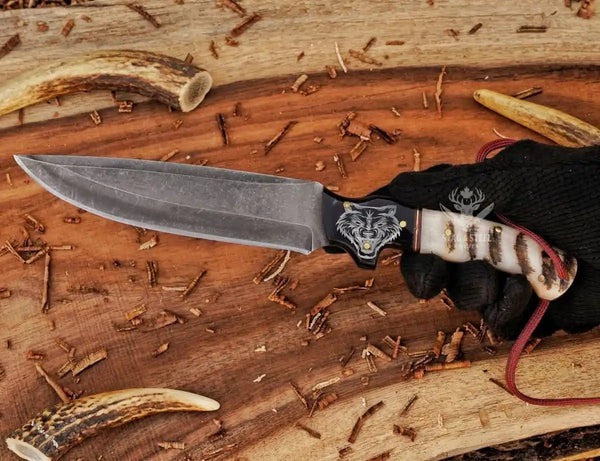 Outdoor D2 hunting knife with leather sheath on wooden surface