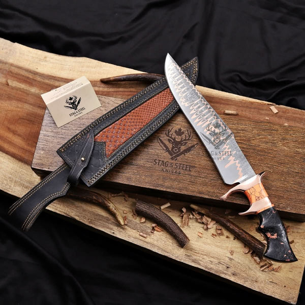Premium Cu-Mai Bowie knife with a solid copper guard and custom resin handle, displayed with a textured leather sheath, wooden presentation box, and Stag & Steel branding.