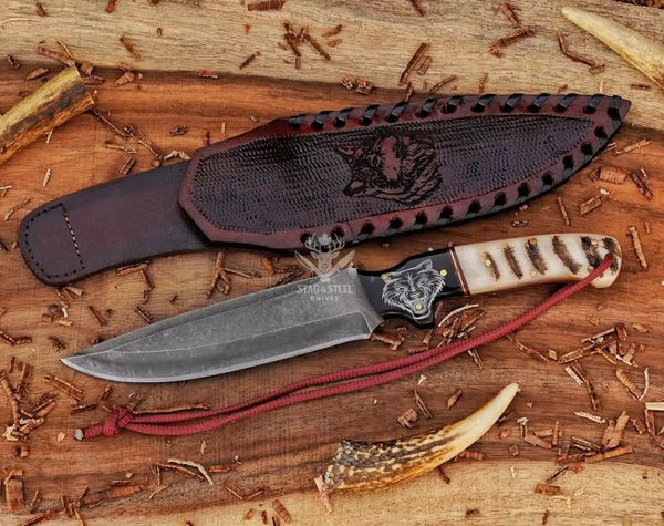 Premium D2 hunting knife with engraved wolf artwork and leather sheath