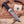 A Stag & Steel fixed-blade knife with a patterned Damascus-style steel blade and a dark wood handle, displayed diagonally on a wooden surface with wood shavings and antlers. The Stag & Steel brand card is visible next to the knife.