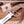 A Stag & Steel fixed-blade knife with a silver steel blade and a textured brown wooden handle, displayed on a wooden surface with antler props and its branded paper tag.