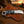  Hawkbill knife with a resin handle, resting on a Pancake leather sheath with rasp steel blade