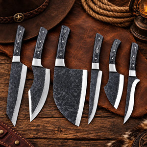 Kurouchi kitchen knife set laid out on an open leather storage roll