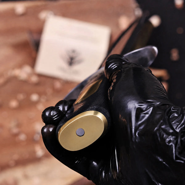Brass Pummel cap macro on black G10 handle of Jim Bowie Edition bowie knife