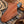Brown leather knife sheath on a wooden surface with rope and leather background