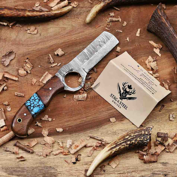 Handcrafted knife with wooden handle and turquoise inlay on a wooden surface with Stag & Steel Knives branding.