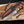 Copper Damascus Bowie Knife with Double Guard along side  its custom leather sheath