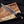 copper damascus bowie knife held in hand