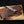 Knife with leather sheath on a wooden surface