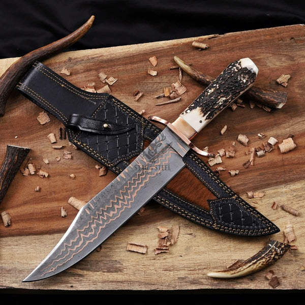 copper damascus knife with leather sheath laid flat