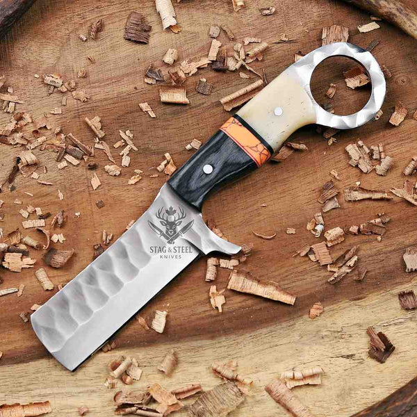 Knife with decorative handle on a wooden surface with wood shavings