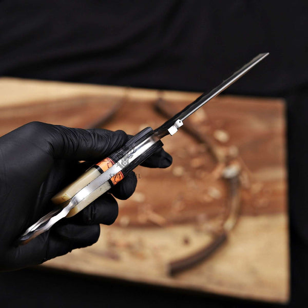 Hand holding a knife with a blurred background