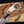 Close-up of a knife handle with wooden and metal design on a blurred background
