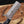 Knife with a black handle and visible brand logo on a wooden background