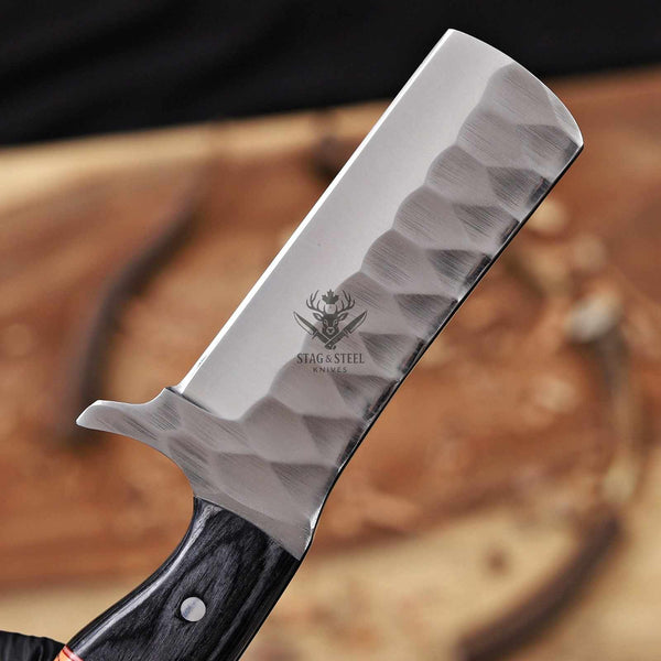 Knife with a black handle and visible brand logo on a wooden background