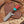 Cowboy Bull Cutter knife with a red and turquoise handle on a wooden background