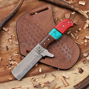 Cowboy Bull Cutter knife with a red and turquoise handle on a wooden background