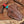 Brown leather sheath with red and turquoise handle on a wooden background