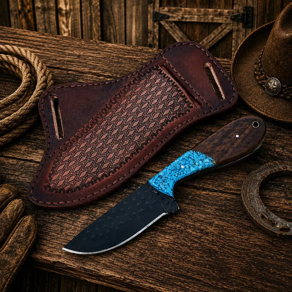 Knife with blue handle and brown leather sheath on wooden surface with cowboy hat and rope.
