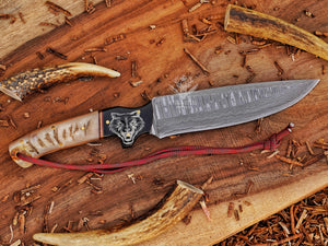 Custom damascus hunter knife with wolf engraved handle and full tang design