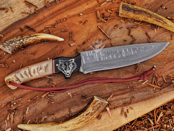 Custom damascus hunter knife with wolf engraved handle and full tang design