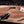 Spine view of D2 Iron Mistress bowie knife showing brass strip held in hand