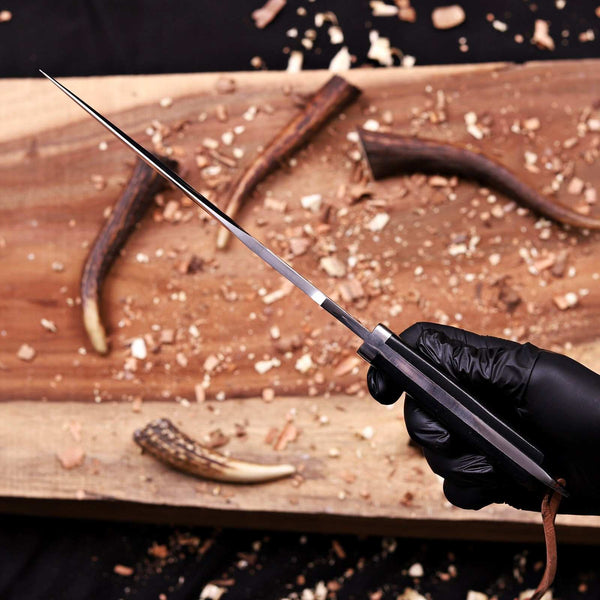 Spear-point tip of a handmade 5mm D2 steel bowie knife