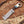 Decorative knife with a wooden handle on a wooden surface with wood shavings.