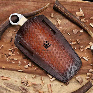 Brown leather case with embossed pattern on a wooden surface with wood shavings