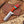 Knife with wooden handle and leather sheath on a wooden background