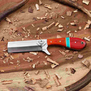 Wooden-handled knife with red and blue accents on a wooden surface with wood shavings.
