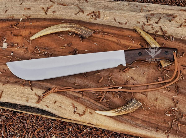 Full view of handmade D2 machete knife with Ironwood handle, blade tip pointing left, and paracord laid on wooden background