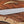 D2 machete knife with satin blade and Ironwood handle displayed on rustic wood with paracord