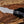 D2 tracker knife with black Micarta handle shown in hand for grip, blade shape, and size reference