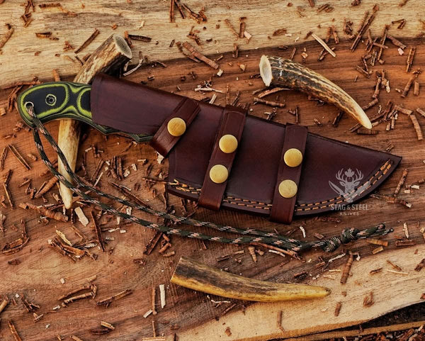 Handmade D2 tracker knife inside brown leather dual-wear sheath with Micarta handle and brass snap straps