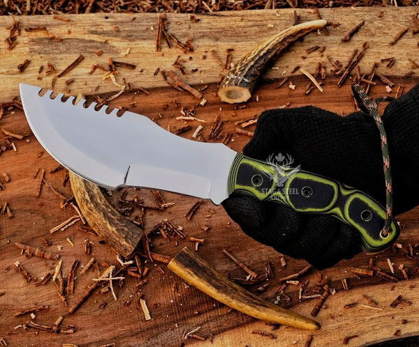 D2 tracker knife with green Micarta handle shown in hand for grip, blade shape, and size reference