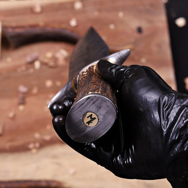 Damascus Steel Pommel view of antler horn handle on Feather Damascus bowie knife with Maker Signature