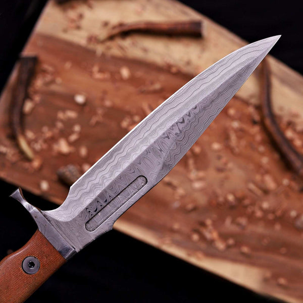 Clip-point tip of a handmade VG10 Damascus bowie knife