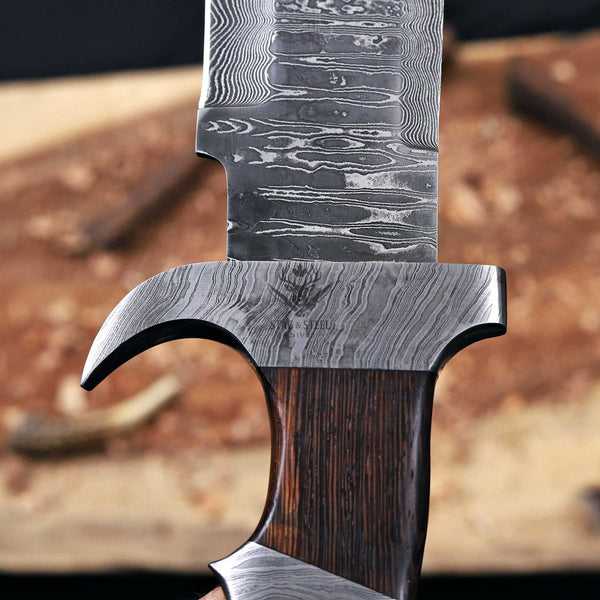 Close-up of Damascus steel guard and blade pattern on Predator bowie knife