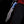 Damascus finger guard bowie knife held at the side against black background