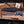 San Mai Damascus bowie knife beside croc-embossed Italian leather sheath