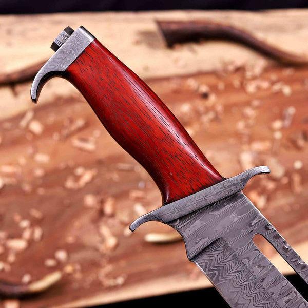Damascus pommel and red pakka wood handle macro detail