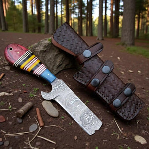 bull cutter Knife with a leather sheath on a forest floor