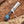 Decorative knife with a blue stone handle on a wooden surface