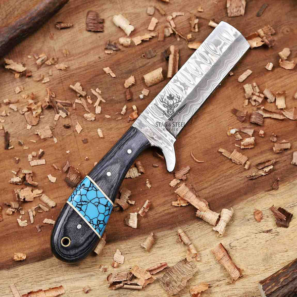 Decorative knife with a blue stone handle on a wooden surface