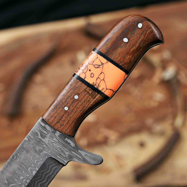 Knife with wooden handle and orange inlay on a blurred background