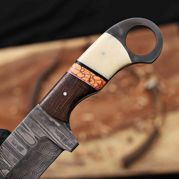 Decorative knife with a wooden handle and intricate blade design on a blurred background