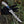 Hand holding fillet knife with a decorative handle against a natural background