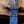 Macro of forged Damascus finger double guard and blue resin handle on bowie knife
