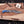 Top-down flat lay of Damascus finger guard bowie knife with blue resin handle